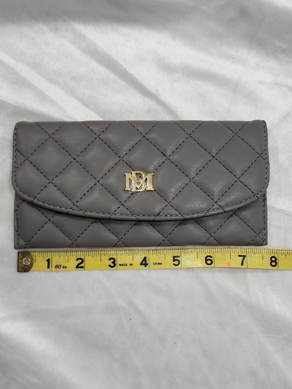 Badgley Mischka Quilted Vegan Leather Wallet. Gray. Gold-toned "BM" Logo Front
